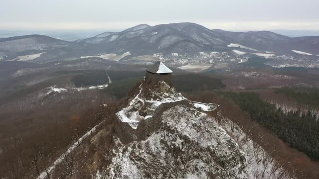 Hungary - Salgo castle covered with snow in winter from drone view