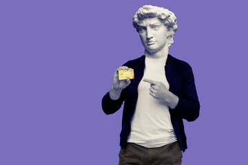 Abstract modern collage. The man with the plaster head of David pointing finger gold credit card on a purple background.