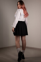 Plump teen girl posing in school uniform