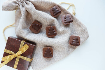 a small gift box and a set of chocolates in a gift bag. gift concept