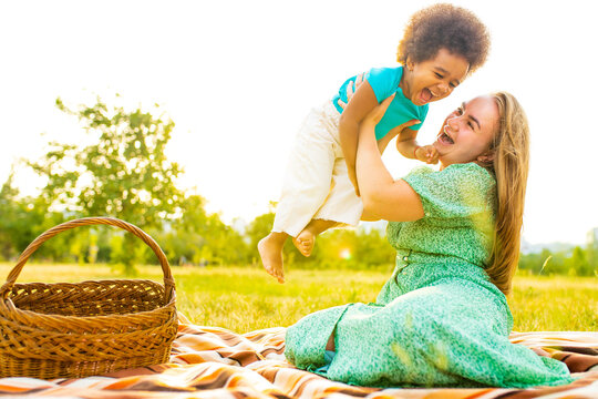 happy mother and cute adorable little girl at pinic in summer park