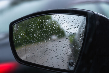 Car mirror after rain. Drops on the mirror.