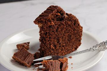 Close-up view of a piece of homemade chocolate cake. Served on a cake plate.