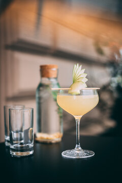 Appletini cocktail served with fresh apple garnishing on the top
