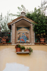 Altar with the image of the Virgin Mary and the baby Jesus on an exterior facade, in Pigneto, a neighborhood in Rome