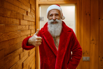 Santa Claus in red bathrobe in sauna - obrazy, fototapety, plakaty