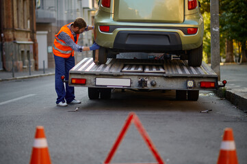 Warning triangle and traffic cone on road