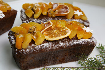 Traditional  Christmas stollen on white background. Dessert is decorated with dried fruits and candied fruits.