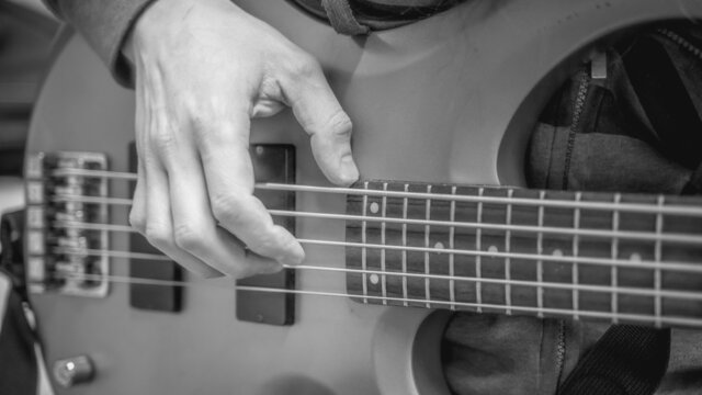 musician playing guitar black and white image, close up
