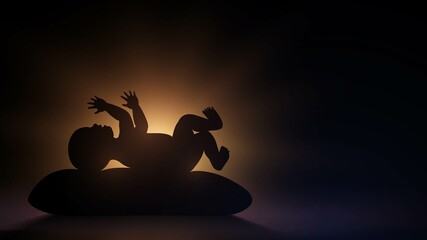 Silhouette of a baby lying on a pillow against the background of light in a dark room