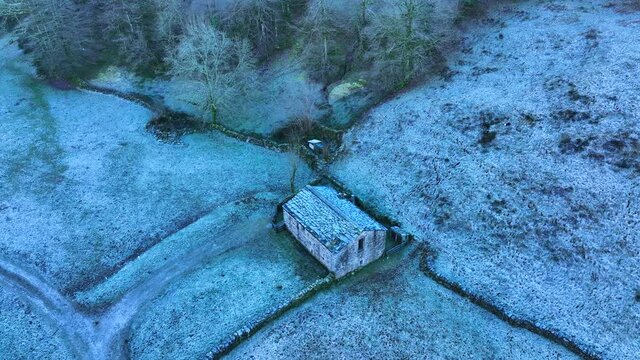 Winter landscape of forests and Pasiega cabins in the Pisue&ntilde;a River Valley. Pasiegos Valleys, Cantabria, Spain, Europe