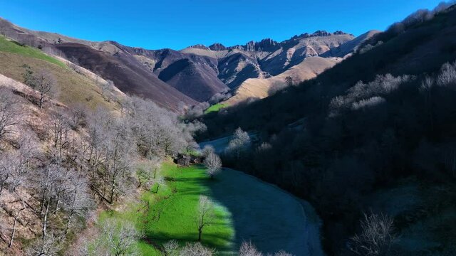 Winter landscape of forests and Pasiega cabins in the Pisue&ntilde;a River Valley. Pasiegos Valleys, Cantabria, Spain, Europe