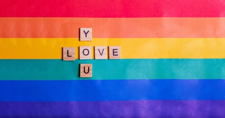 Love you inscription with rainbow Flag. The concept of rainbow love. Human rights and tolerance. Poster, postcard, banner and background.