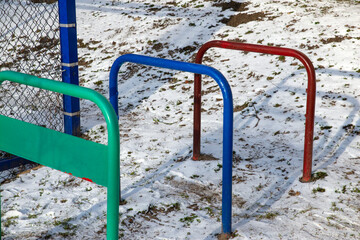 metal constructions for sports on the playground covered with snow
