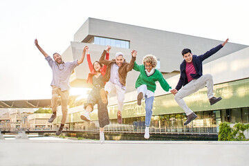 Diversity happy group of friends jumping togethers at campus.