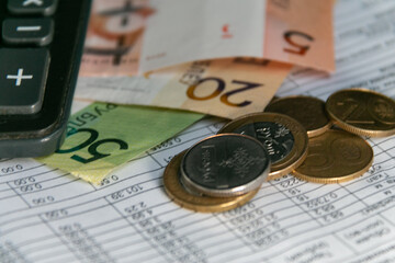 Calculator, Belarusian money, and a receipt for payment of utility bills in Belarus. The concept of paying bills and increasing prices. Close-up. Selective focus, narrow focus. Blurred background.