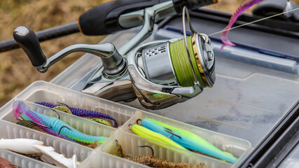 A large fisherman's tackle box fully stocked with lures and gear for fishing.fishing lures and accessories. fishing spinning. Kit of fishing lures.