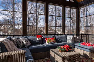 Cozy screened porch winter during Holidays season, snowy roofs and woods in the background.