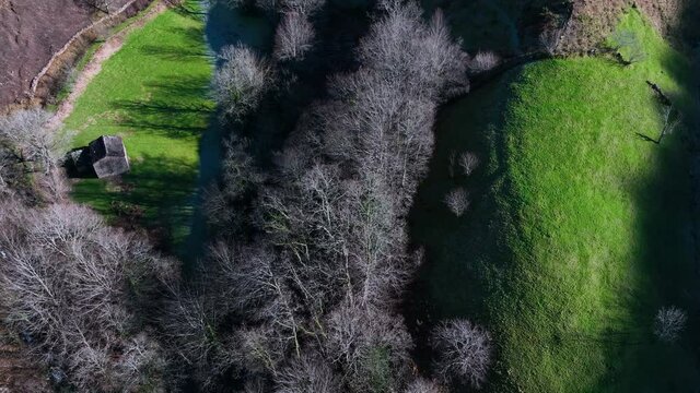 Winter landscape of forests and Pasiega cabins in the Pisue&ntilde;a River Valley. Pasiegos Valleys, Cantabria, Spain, Europe