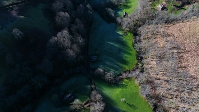 Winter landscape of forests and Pasiega cabins in the Pisue&ntilde;a River Valley. Pasiegos Valleys, Cantabria, Spain, Europe