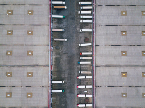 4k Aerial shot of trucks on warehouse parking terminal. Russia.