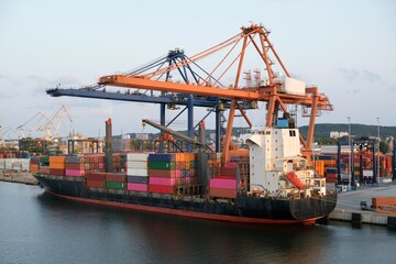 A big container ship during loading in the port