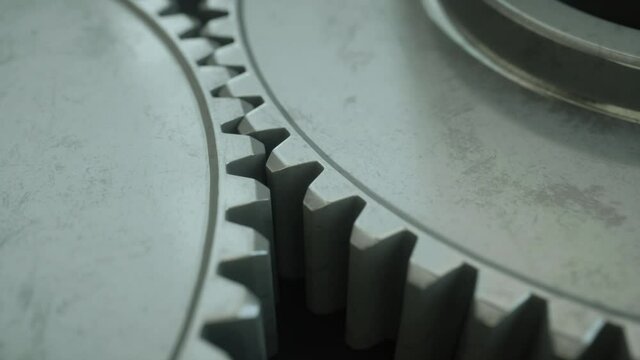 Closeup on slowly rotating iron metallic gears, rotating industrial engine steel wheels. Symbol of teamwork, industry or business. Iron clockwork machinery in motion. 4k realistic 3d animation loop