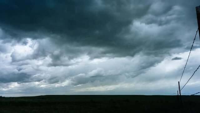 time lapse of turbulent stormy rain clouds over green wyoming pasture