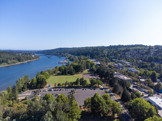 Beautiful panorama. A small town on the bank of a big blue river. Lots of greenery, hilly terrain, paved roads. Beautiful bridge over the river. Planning, housing issue, ecology.