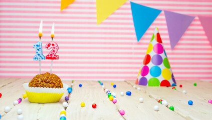Happy birthday for 12 years old. Festive background with muffin. Copy a birthday card for a twelve...