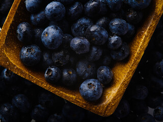 Close-up. Blueberries in a large yellow bowl. Culinary - an ingredient for the preparation of sauces, sweet dishes, juices, fresh juices. Breakfast supplement, vitamins, antioxidants.