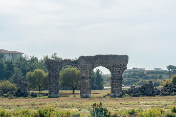 Fototapeta na wymiar ruin of an ancient Roman aqueduct in a city wasteland near the ancient city of Side in Turkey
