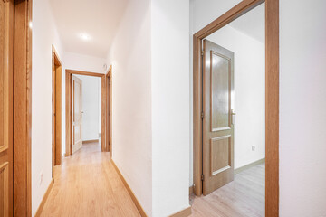 Hallway in an empty home with oak carpentry on doors and floors