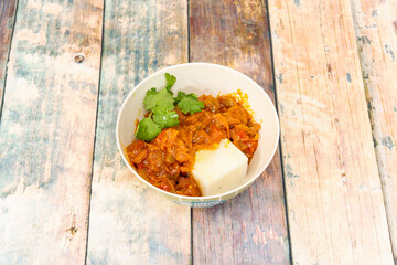 Chakalaka is a somewhat spicy vegetarian stew that uses very few ingredients. It is common to serve it with polenta