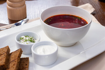 Borscht with sour cream and beef side view