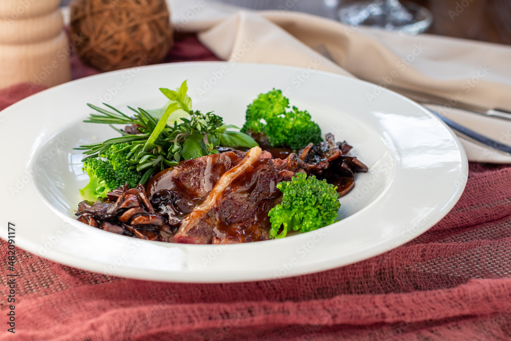 Sticker Steak salad with beef and vegetables on a white plate