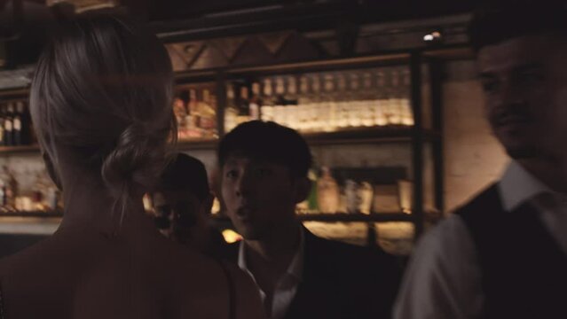 Woman Walking In To Bar As Men Stare At Her