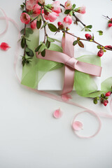 spring greeting card layout. blossoming branches of cherry and gift box 