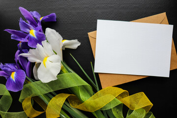 spring bouquet. a bouquet of irises and an envelope with a blank for text. spring time. spring greeting card. congratulation. invitation