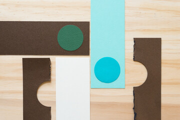 paper circles and rectangles (some semi circles) on wood