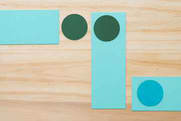 paper circles and rectangles on wood