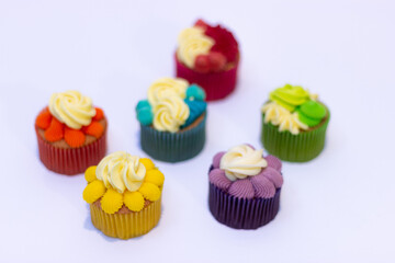 group of rainbow colored cupcakes green yellow red purple blue