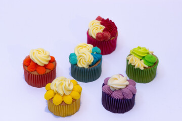 group of rainbow colored cupcakes green yellow red purple blue
