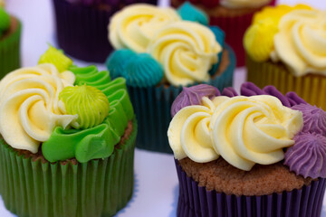 group of rainbow colored cupcakes green yellow red purple blue