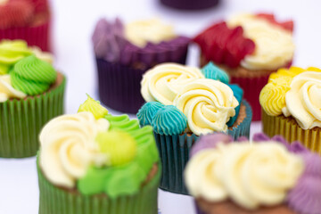 group of rainbow colored cupcakes green yellow red purple blue