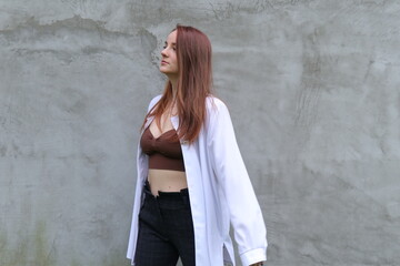 portrait of a girl in white shirt, concrete background