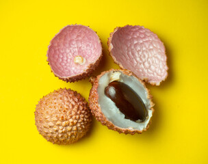 Sliced ​​lychee. Chinese plum.  Purified Lychee. Pieces of juicy fruit on a bright background.