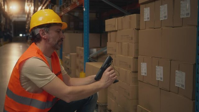 Man scanning packages in warehouse