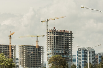 Fototapeta na wymiar Tower crane, development of urban structures and construction of houses industry architecture