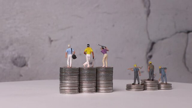 Miniatures and piles of coins with business concepts. Concept about economic inequality.
